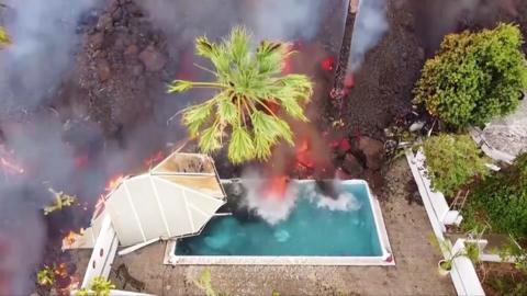 Lava pours into a swimming pool in La Palma