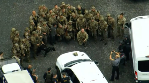 Police posing with Cavalcante