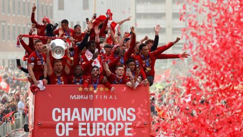 Liverpool's team bus travels past fans during the parade