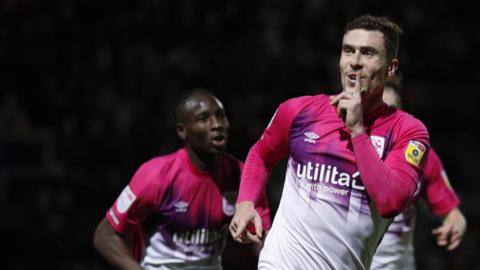 Josh Ruffels celebrates one of his goals for Huddersfield Town at QPR