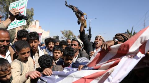Supporters of Yemen's rebel Houthi movement protest in Sanaa against a decision by the Trump administration to declare it a foreign terrorist organisation (18 January 2021)
