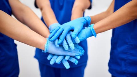 Medical staff with hands together