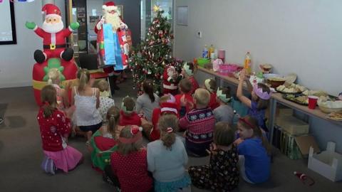 Father Christmas visits children