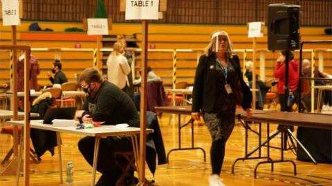 Election officials in face masks at Mill House Leisure Centre wait for ballot boxes to arrive before they can start counting in the Hartlepool parliamentary by-election,