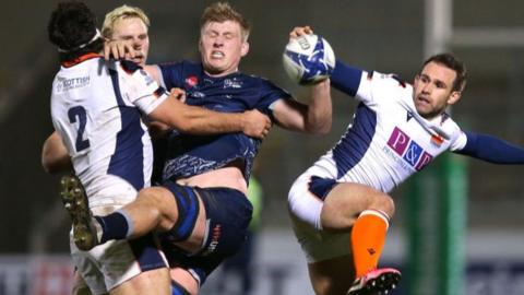 Nic Groom of Edinburgh challenges Matt Postlethwaite of Sale Sharks