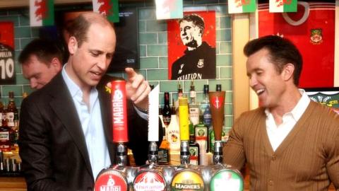 Prince William pulls a pint at the Turf pub in Wrexham with Rob McElhenney