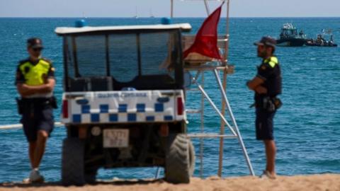 Police guard at Barcelona's Sant Sebastià beach. Photo: 25 August 2019