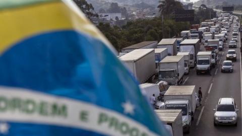 Brazilian truck drivers block the Imigrantes road, 23 kilometres from Sao Paulo, during the fourth day of strike to protest rising fuel costs in Brazil, on May 24, 2018.