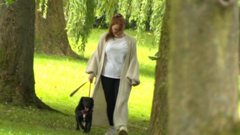 Chloe Ambler walking with her dog