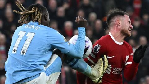 Manchester City's Jeremy Doku challenges Liverpool's Alexis Mac Allister in the final seconds of the 1-1 Premier League draw between their sides