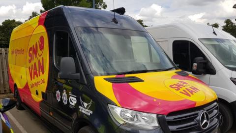 Van parked in car park that will help people in the evening