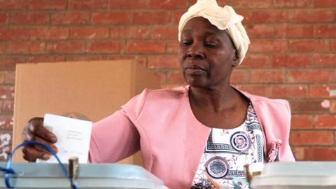 A voter casts her ballot at Emakhandeni Secondary School during general elections in Bulawayo, Zimbabwe, August 23, 2023