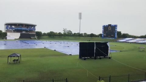 The covers on as rain falls at the MRIC Stadium in Hambantota, Sri Lanka on day two of England's warm-up match