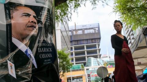 A woman walks past an advertisement picture of US President Barack Obama promoting the book "Leadership, the Barack Obama way" by Shel Leanne translated into Vietnamese outside a book store in Ho Chi Minh City, Vietnam, 22 May 2016