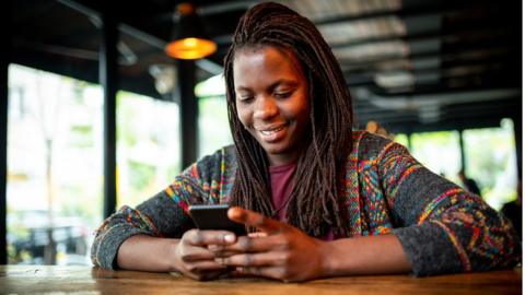 A young woman using a phone