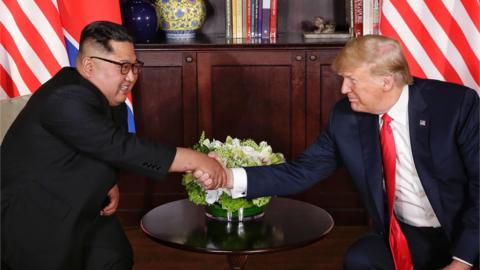 Kim Jong-un and Donald Trump shake hands in Singapore