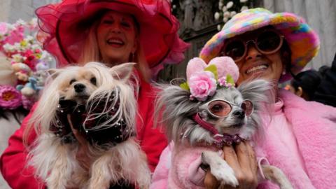 Leslie and her dog Puccini and Joanna and her dog Chichi Love take part in the annual Easter Parade and Bonnet Festival on 5th Avenue outside St. Patrick's Cathedral in Manhattan in New York City, U.S., March 31, 2024.