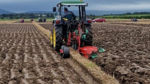 tractor ploughing field at championships in Limavady