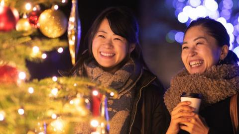 Japanese women looking at Christmas tree