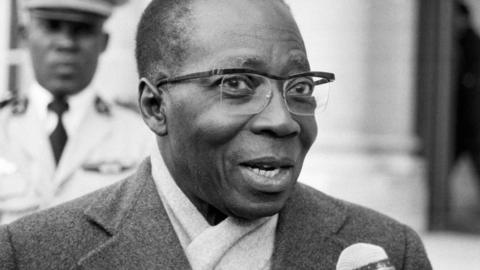 Léopold Sédar Senghor speaks into a microphone in 1984.