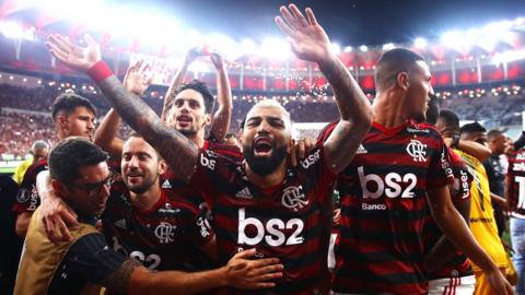 Flamengo players celebrate at the final whistle after beating Gremio to reach the Copa Libertadores final