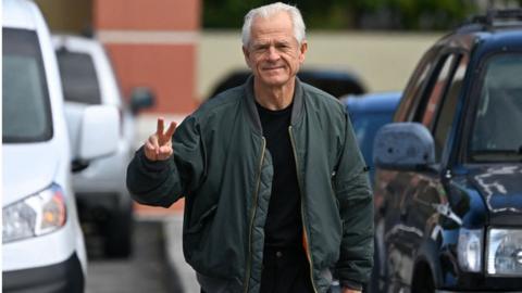 Peter Navarro in green jacket and black T shirt