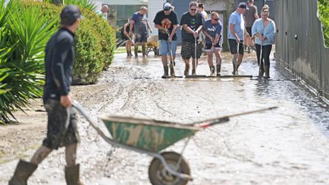 Residents in Taradale clean up silt following flood waters on February 15, 2023 in Napier, New Zealand