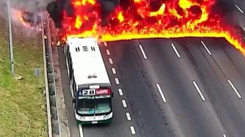 Fuel from burning bus spreads flames across highway