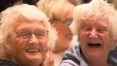 Two women enjoying the concert