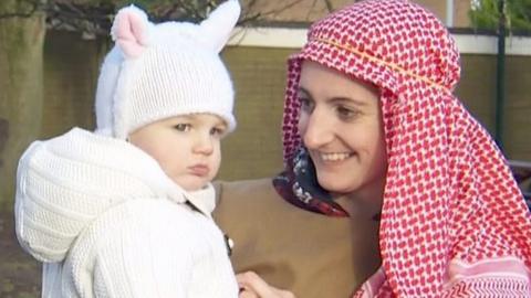 Woman dressed as shepherd and child dressed as sheep