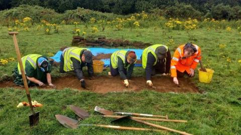 Volunteers excavating site