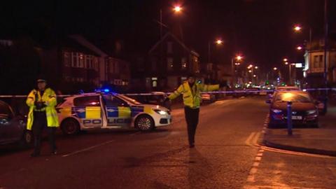 Police officers direct traffic away from the accident scene