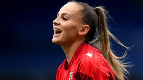 Lily Woodham laughs with team-mates during Reading warm up