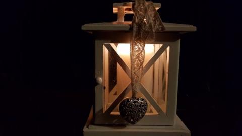 An image of a candle burning in remembrance of those who lost their lives in Kristallnacht