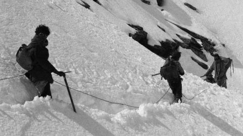 Mountaineers trudge through deep snow