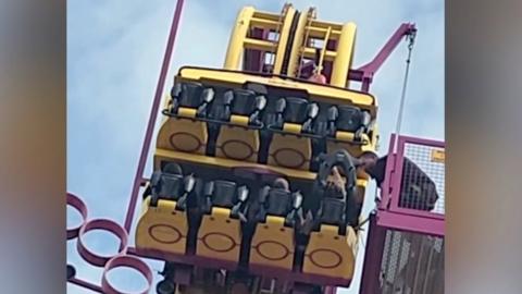 A team rescues passengers from a broken down rollercoaster