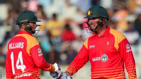 Two Zimbabwe batsman shake hands