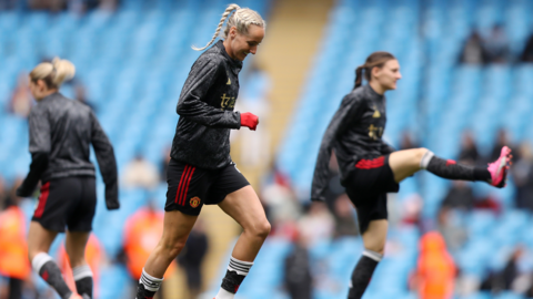 Players warm-up at Etihad Stadium before the start of Manchester City and Manchester United in the Women's Super League