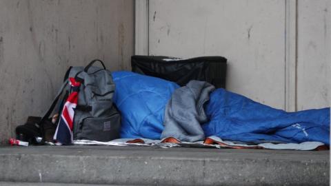 File photo of a homeless person sleeping rough in a doorway