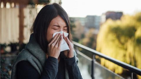 Woman sneezing