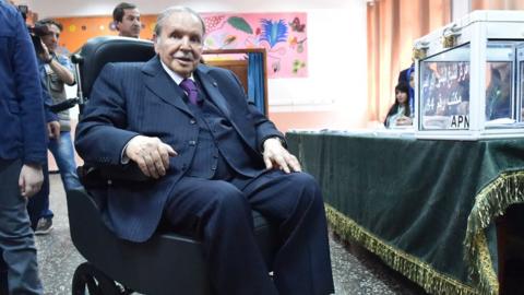 Algerian President Abdelaziz Bouteflika is seen on a wheelchair as he casts his vote at a polling station in 2017