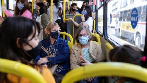 People wearing protective face masks ride a bus, as the spread of the coronavirus disease (COVID-19) continues in Montevideo, Uruguay November 18, 2020.