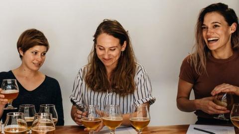 Charles Denby and colleagues tasting beers made with his firm's yeast strains