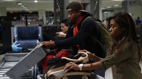 Passengers at an airport security screening