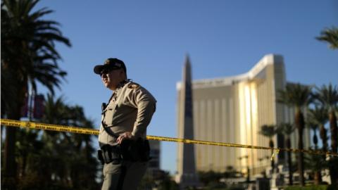 An officer stands outside of Mandalay Bay hotel