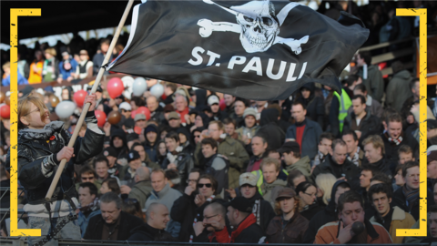 A St Pauli fan waves a club flag