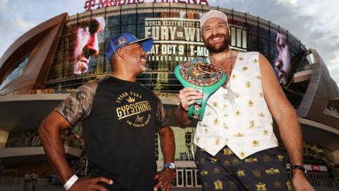 SugarHill Stewards grins beside Tyson Fury