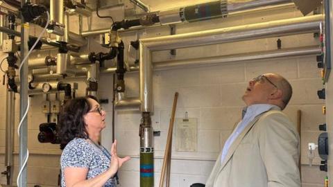 Robert Halfon MP looking up at a ceiling/roof built using Raac