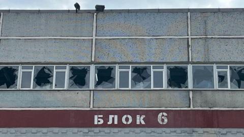 A view shows broken windows at a building labelled "Block 6" of the Russian-controlled Zaporizhzhia Nuclear Power Plant during a visit by members of the International Atomic Energy Agency (IAEA) expert mission, (picture released September 2, 2022)