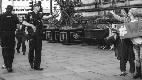 Durham Police officer blowing a kiss to a woman offering free hugs after the Manchester bomb attack